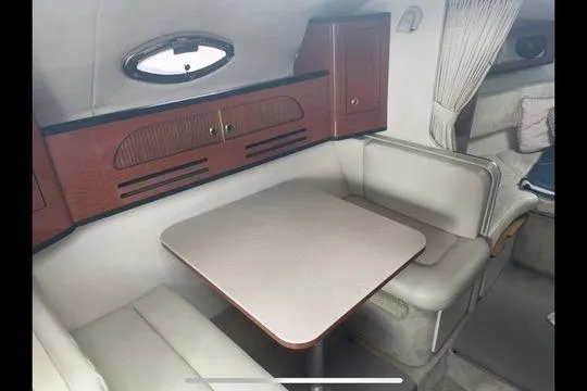 Slide: The Image of Interior of 2004 Sea Ray Sundancer 280 with dining area and seating. - 8