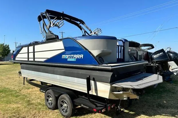 Slide: The Image of 2023 Montara 23 Surf Boss 2.0 CW boat on trailer, side view. - 2