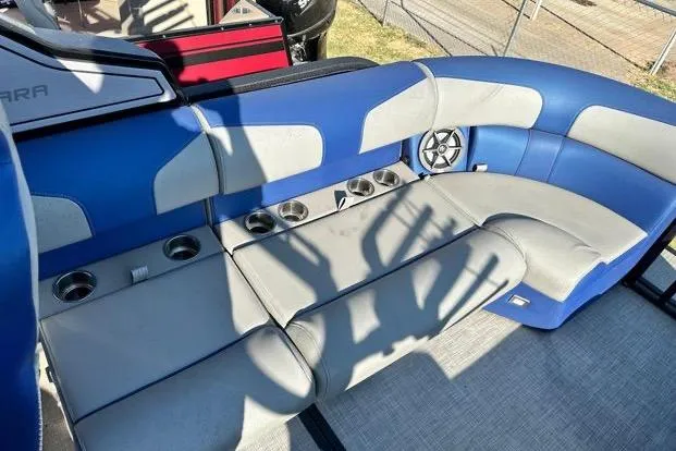 Slide: The Image of 2023 Montara 23 Surf Boss 2.0 CW boat interior with blue and gray seating, cup holders. - 6