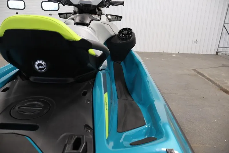 Slide: The Image of 2025 Sea-Doo GTI SE 170 jet ski, blue and yellow, in a garage setting. - 14