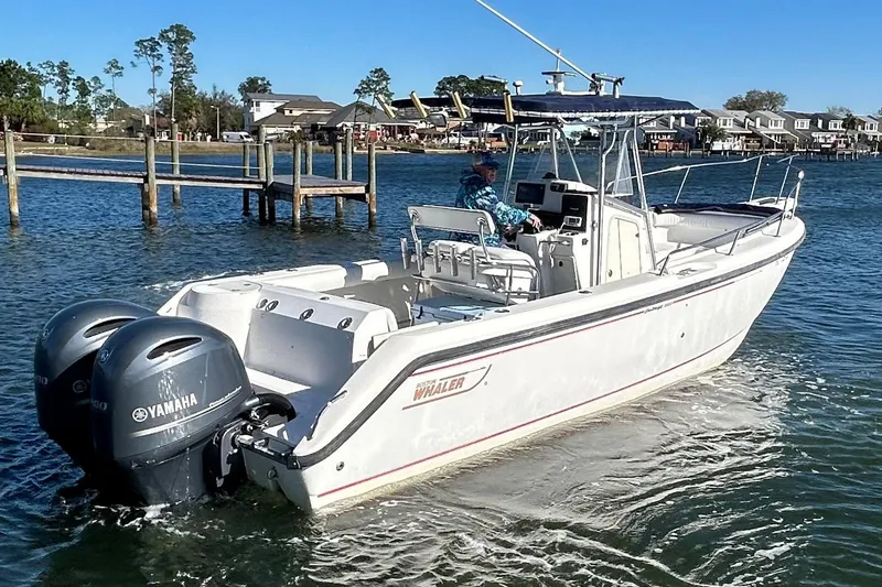 Slide: The Image of 2002 Boston Whaler 260 Outrage boat with dual Yamaha engines on the water. - 1