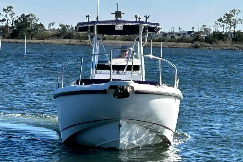 Slide: The Image of 2002 Boston Whaler 260 Outrage boat cruising on a calm lake. - 10