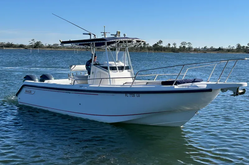 Slide: The Image of 2002 Boston Whaler 260 Outrage boat cruising on a calm lake. - 9
