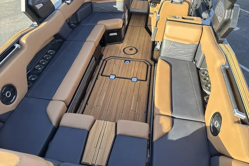 Slide: The Image of Luxurious interior of 2026 Supra SE 550 boat with sleek seating and wood flooring. - 10