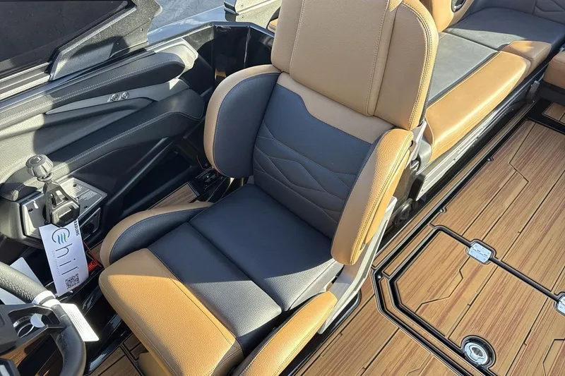 Slide: The Image of 2026 Supra SE 550 interior with tan and black seating, modern design, and wood-style flooring. - 13