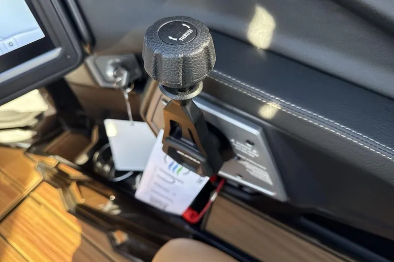 Slide: The Image of Control lever in 2026 Supra SE 550 boat cockpit, featuring sleek design and modern technology. - 16