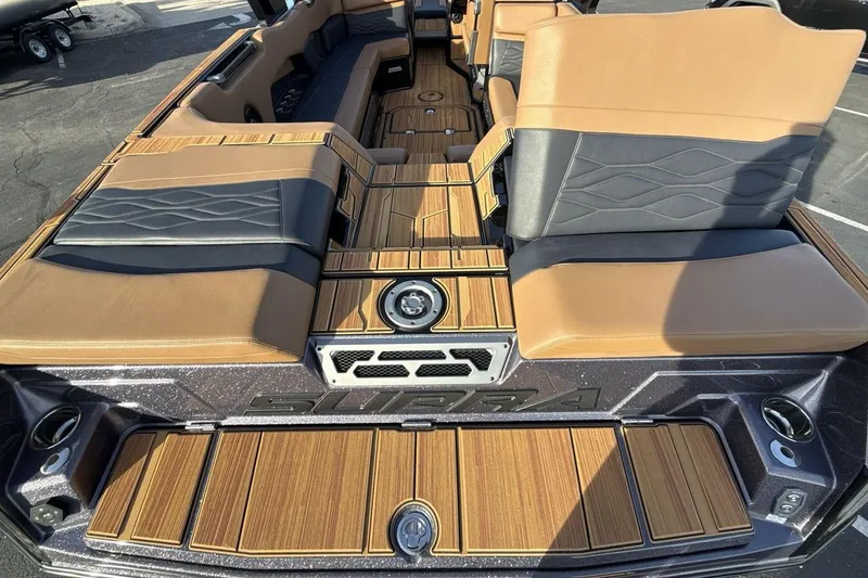 Slide: The Image of 2026 Supra SE 550 boat interior with luxurious tan and gray seating. - 19