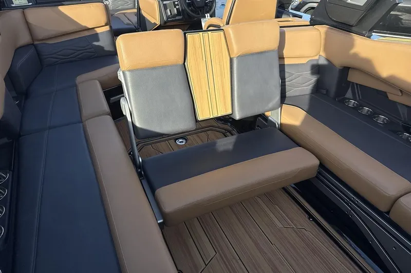 Slide: The Image of Luxurious interior of 2026 Supra SE 550 boat with tan and black seating. - 23