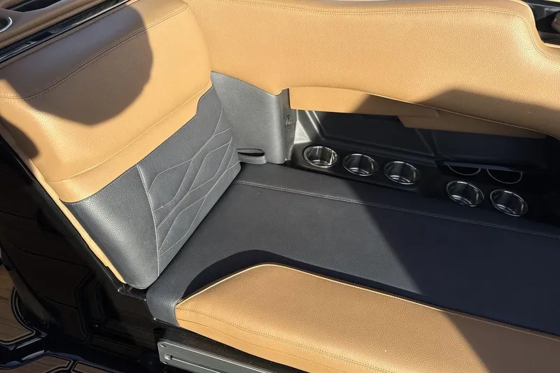 Slide: The Image of 2026 Supra SE 550 interior with tan and black leather seats, featuring multiple cup holders. - 24