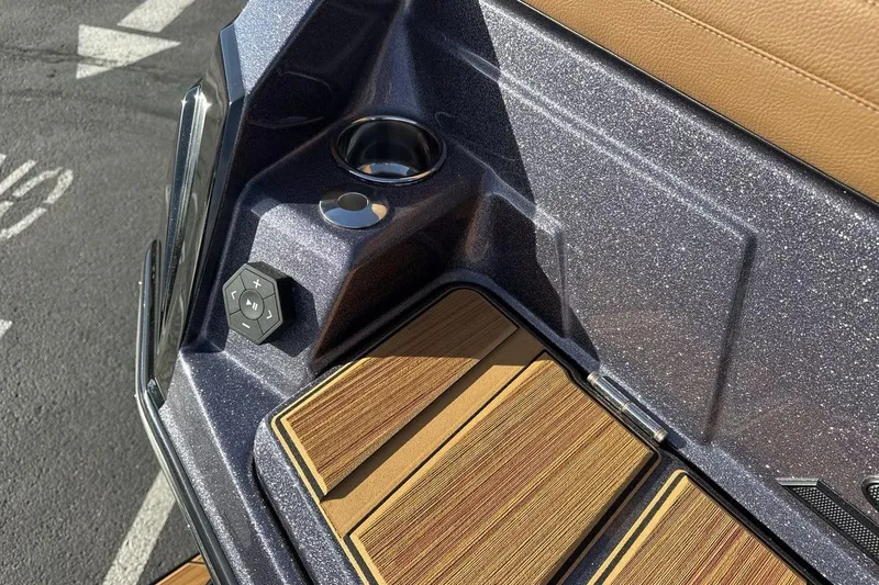Slide: The Image of 2026 Supra SE 550 boat interior with cup holder and control panel. - 26