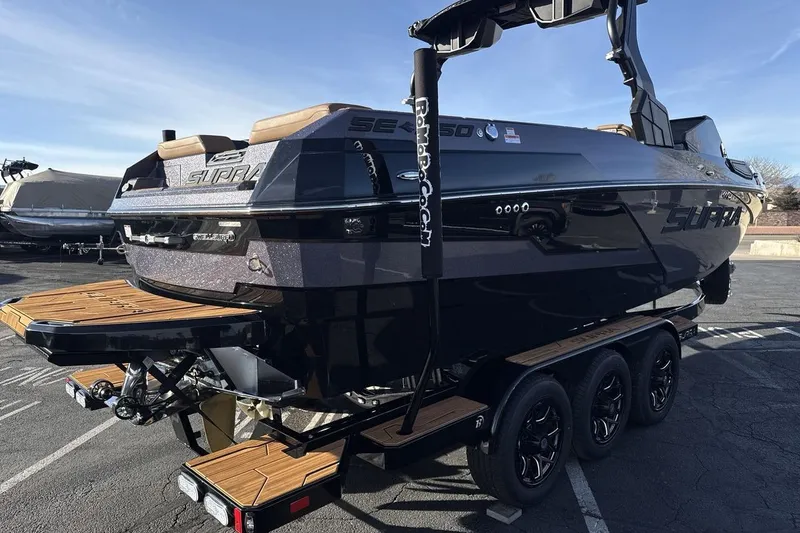 Slide: The Image of 2026 Supra SE 550 boat on trailer, sleek design, parked outdoors. - 5