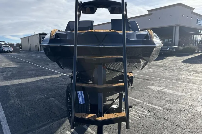 Slide: The Image of 2026 Supra SE 550 boat on trailer in parking lot, rear view. - 8