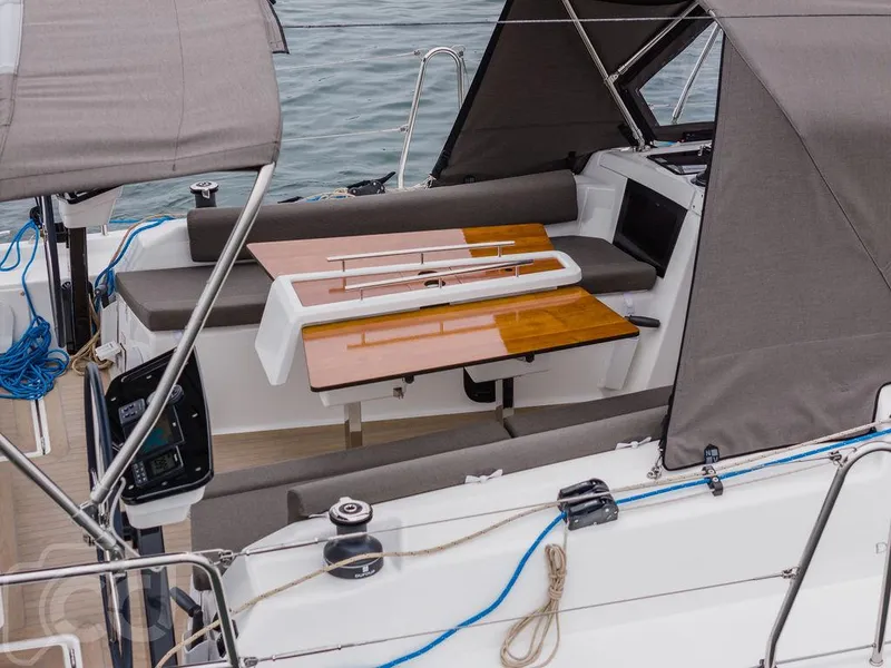 Slide: The Image of 2023 Dufour 37 sailboat cruising on open water with two people onboard. - 14