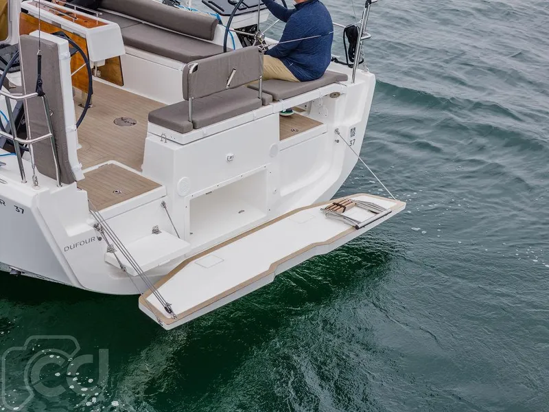 Slide: The Image of 2023 Dufour 37 sailboat on open water with two people onboard. - 15