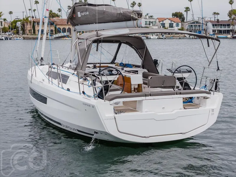 Slide: The Image of 2023 Dufour 37 sailboat on calm water, front view. - 16