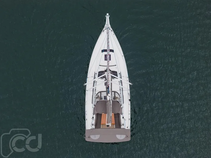 Slide: The Image of 2023 Dufour 37 yacht with open swim platform on calm water. - 18