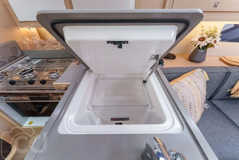 Slide: The Image of 2023 Dufour 37 yacht interior with cozy dining area and modern decor. - 26