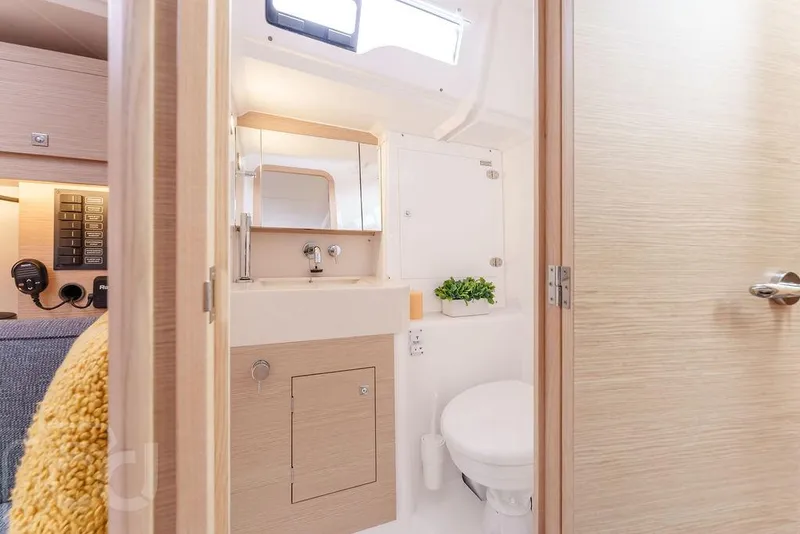 Slide: The Image of Cozy cabin interior of 2023 Dufour 37 yacht with elegant bedding and ambient lighting. - 33