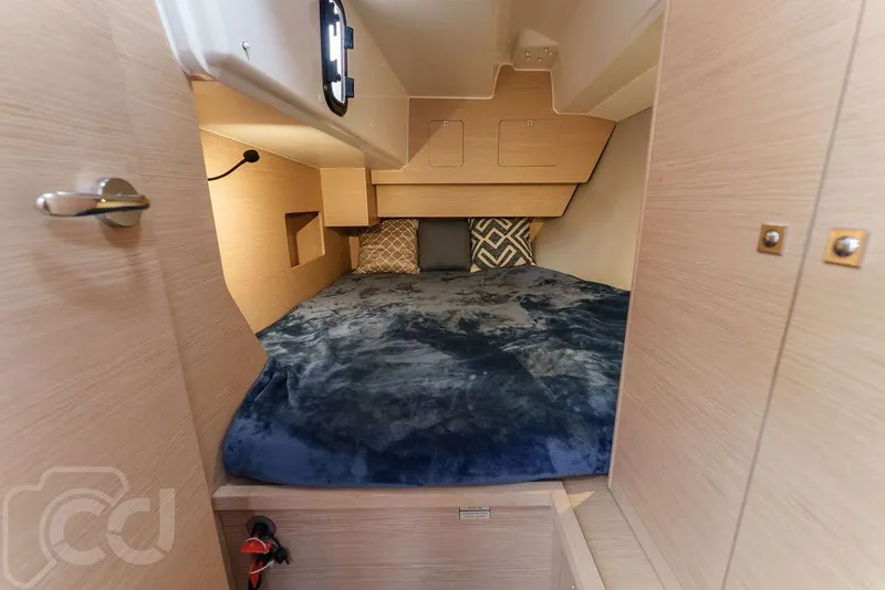 Slide: The Image of Cozy cabin interior of 2023 Dufour 37 yacht with plush bedding and wooden accents. - 37