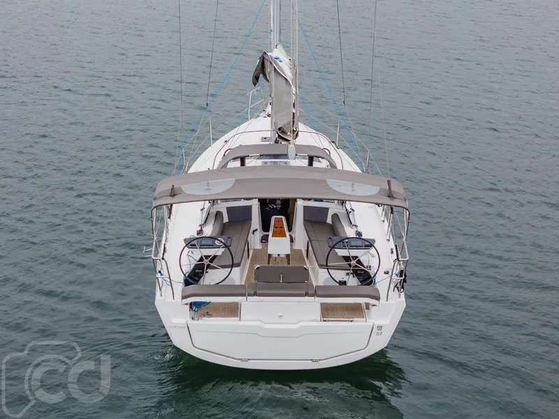 Slide: The Image of 2023 Dufour 37 sailboat cruising on calm waters under cloudy skies. - 5