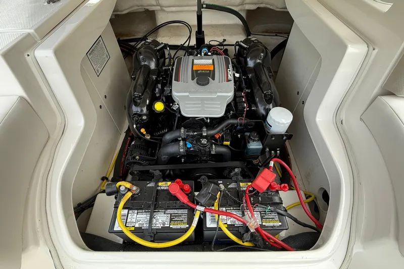 Slide: The Image of Engine compartment of a 2013 Chaparral 246 SSi boat, featuring a clean, organized layout. - 13