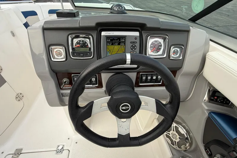 Slide: The Image of Steering wheel and dashboard of 2013 Chaparral 246 SSi boat with navigation system. - 17