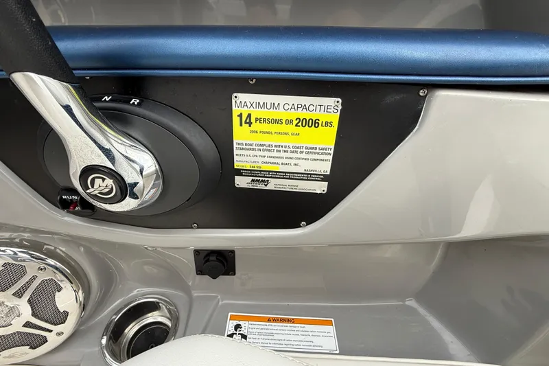 Slide: The Image of Control panel of 2013 Chaparral 246 SSi boat showing capacity label and steering wheel. - 18