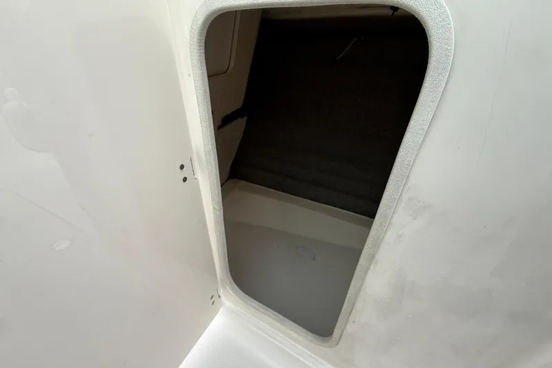 Slide: The Image of Storage compartment inside a 2013 Chaparral 246 SSi boat, featuring a clean interior. - 20