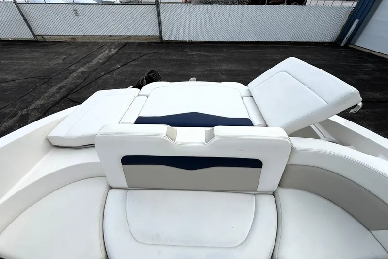 Slide: The Image of 2013 Chaparral 246 SSi boat interior with white and navy seating. - 23