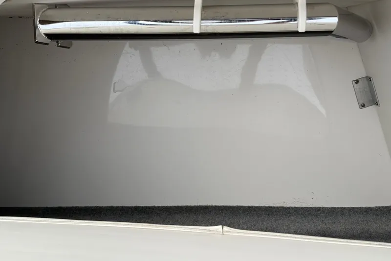 Slide: The Image of Storage compartment of a 2013 Chaparral 246 SSi boat with chrome railing. - 25
