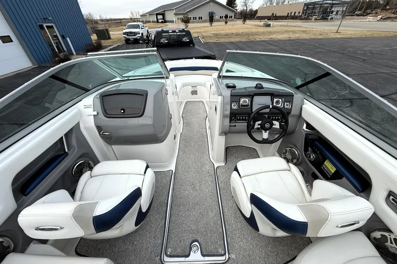 Slide: The Image of 2013 Chaparral 246 SSi boat interior with white seating and modern dashboard. - 27