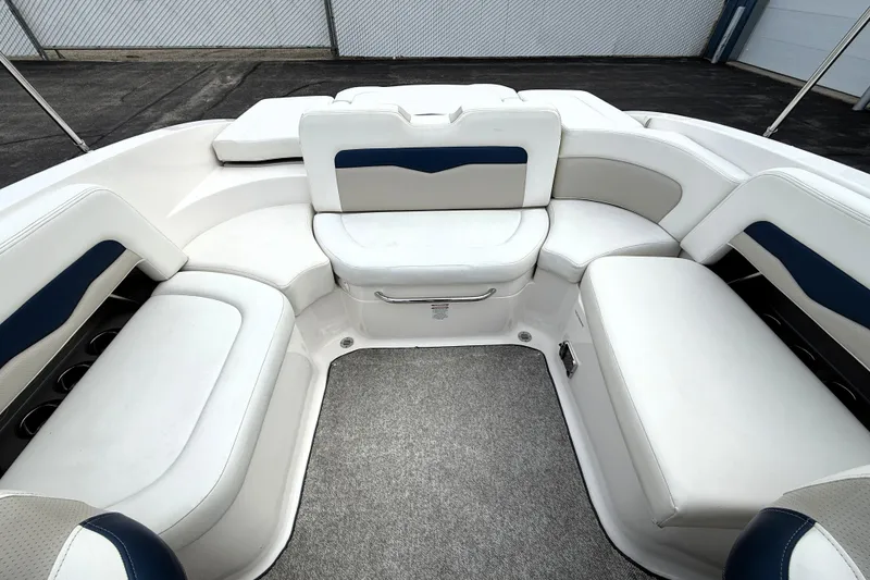 Slide: The Image of 2013 Chaparral 246 SSi boat interior with white and blue cushioned seating. - 29