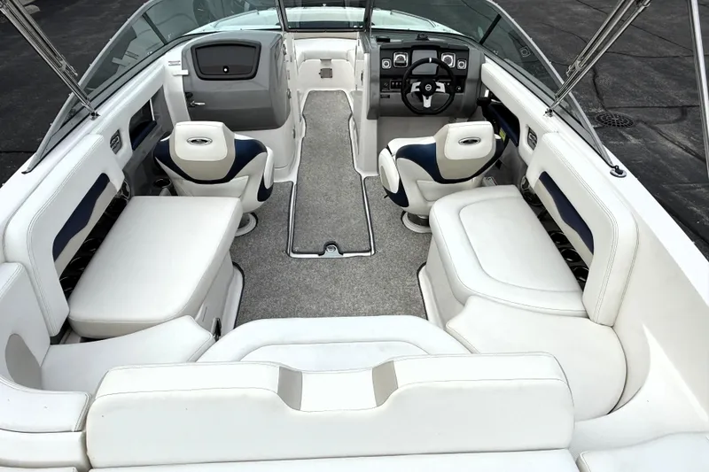 Slide: The Image of 2013 Chaparral 246 SSi boat interior with white seating and modern dashboard. - 30