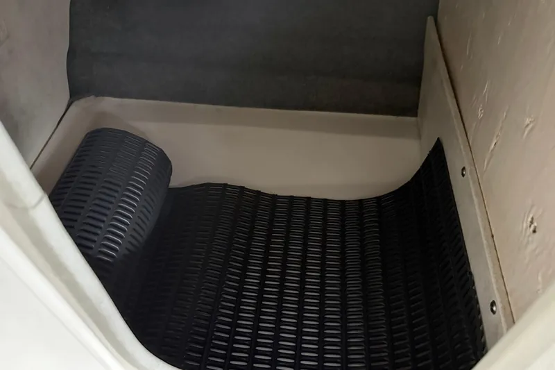 Slide: The Image of Interior storage compartment of 2013 Chaparral 246 SSi boat with black mat. - 32