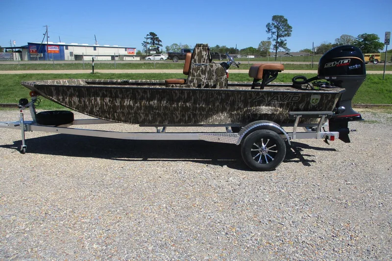 The Image of 2026 Avid 18 Rogue CC boat on trailer, camo design, parked outdoors. - 0