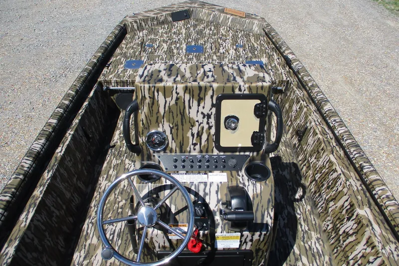 Slide: The Image of Camouflage interior of 2026 Avid 18 Rogue CC boat with steering wheel and controls. - 11
