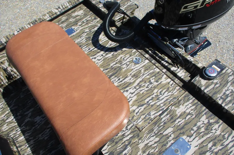 Slide: The Image of Camouflage-patterned deck of 2026 Avid 18 Rogue CC boat with brown seat and motor. - 15