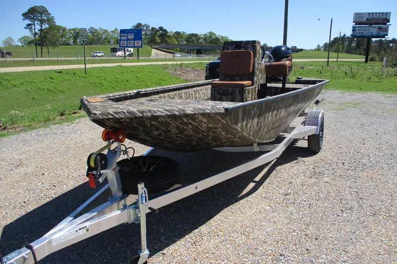 Slide: The Image of 2026 Avid 18 Rogue CC boat on trailer, camo design, parked outdoors. - 4