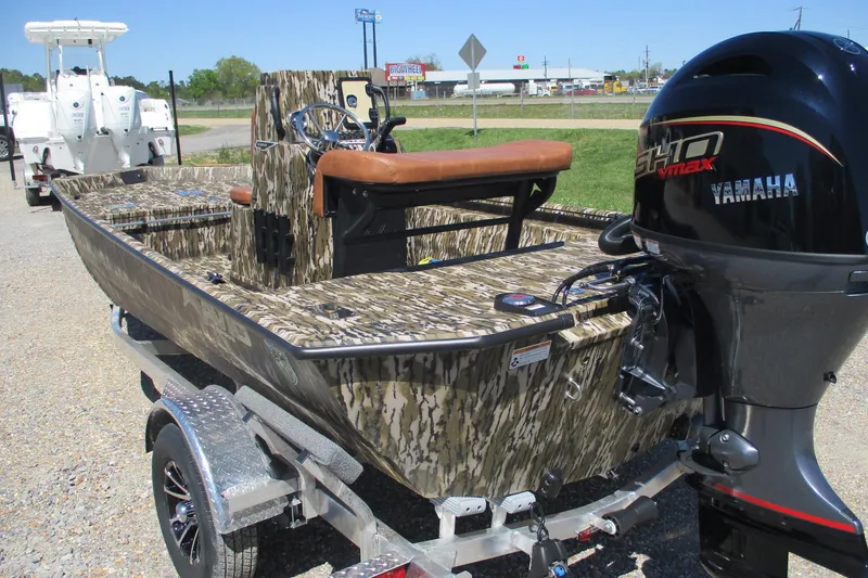 Slide: The Image of 2026 Avid 18 Rogue CC boat with Yamaha engine on trailer, camo design. - 5