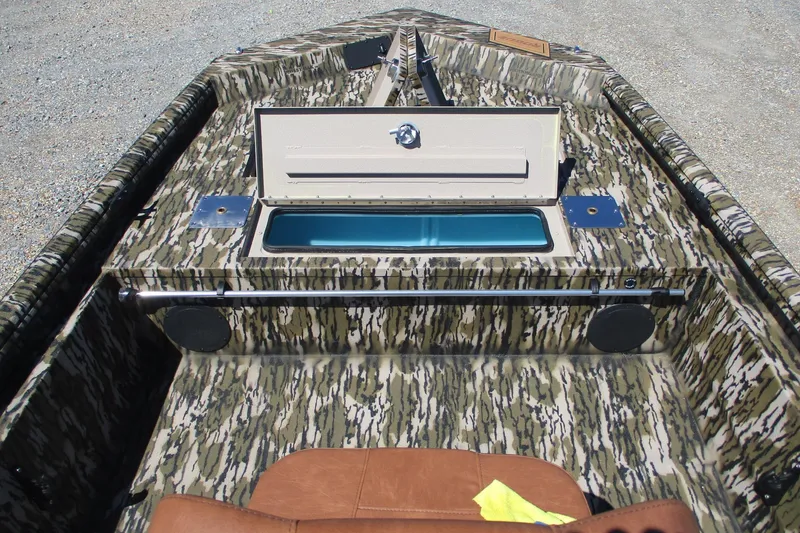 Slide: The Image of 2026 Avid 18 Rogue CC boat interior with camouflage design and open storage compartment. - 9