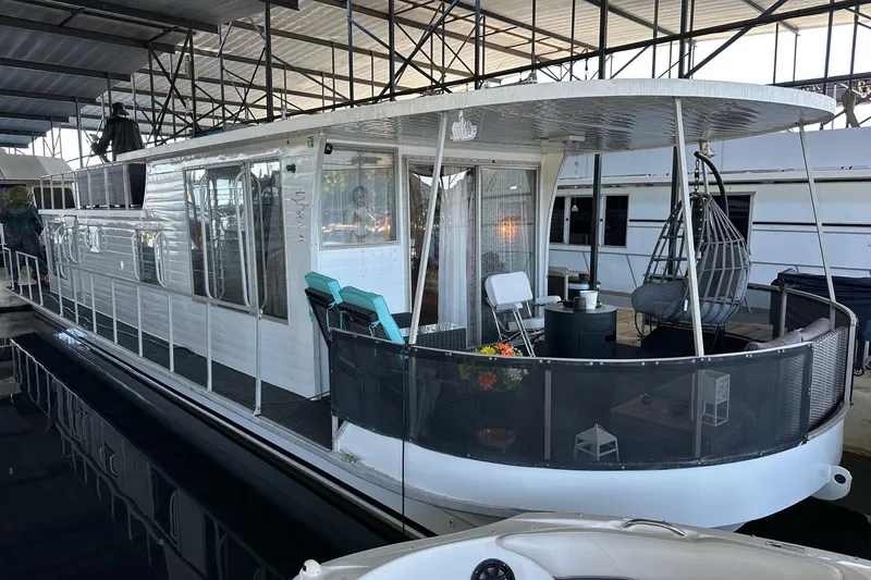 The Image of 1966 Lazy Days houseboat, model 12.6x45, docked with outdoor seating and modern decor. - 0