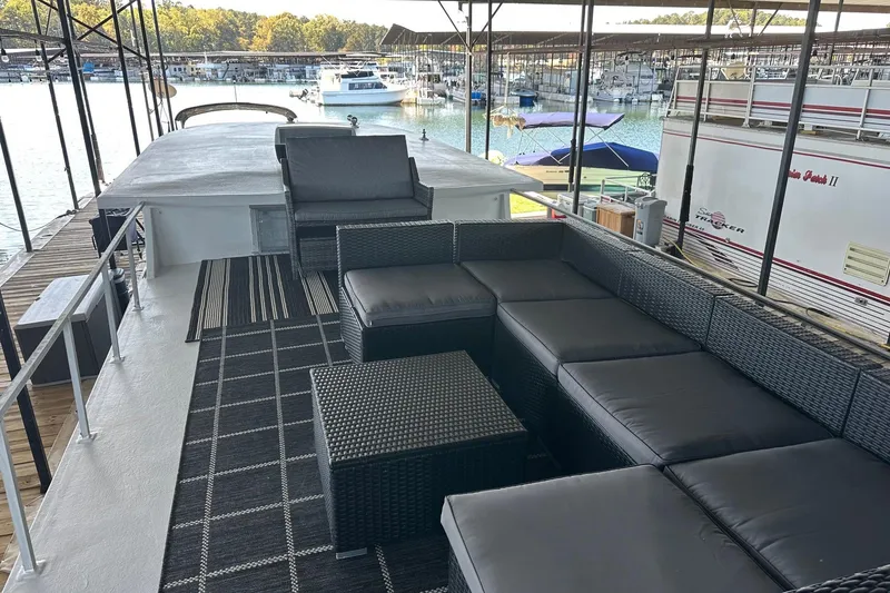 Slide: The Image of 1966 Lazy Days houseboat with outdoor seating, docked at a marina. - 14