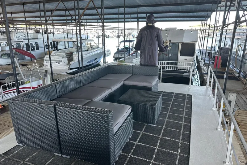 Slide: The Image of Outdoor seating on a 1966 Lazy Days houseboat docked in a marina. - 15