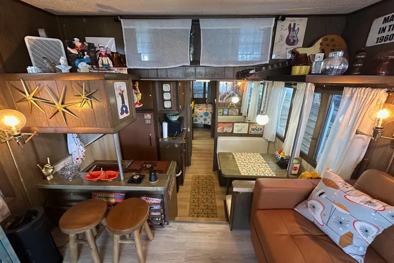 Slide: The Image of Vintage 1966 Lazy Days RV interior with retro decor and cozy seating area. - 4