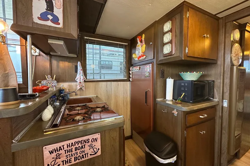 Slide: The Image of Vintage 1966 Lazy Days boat kitchen with retro decor and wooden cabinetry. - 5