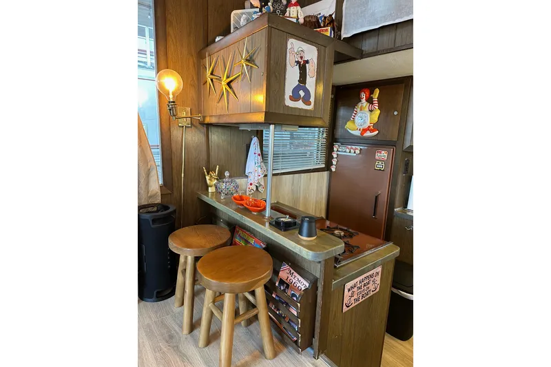 Slide: The Image of Retro 1966 Lazy Days RV kitchen with vintage decor and wooden stools. - 7