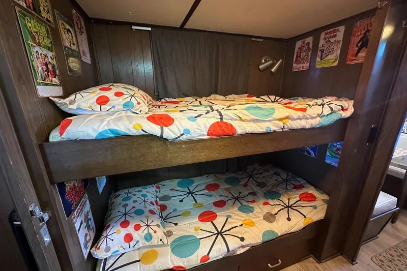 Slide: The Image of Vintage 1966 Lazy Days RV interior with colorful bunk beds and retro decor. - 8