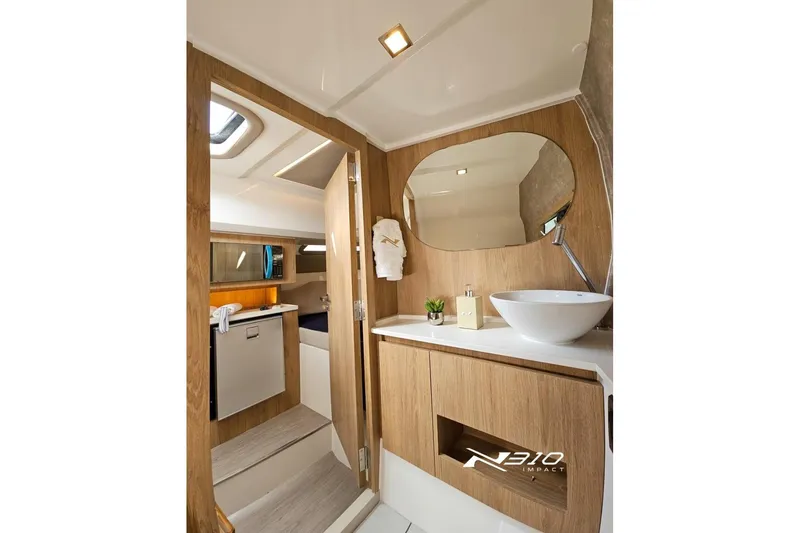Slide: The Image of Luxurious interior of 2026 NX Boats NX310, featuring modern bathroom and kitchenette design. - 3