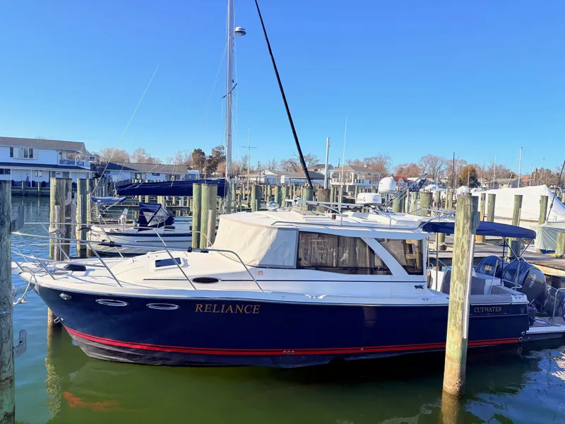 The Image of 2023 Cutwater 32 Coupe boat docked at marina. - 0