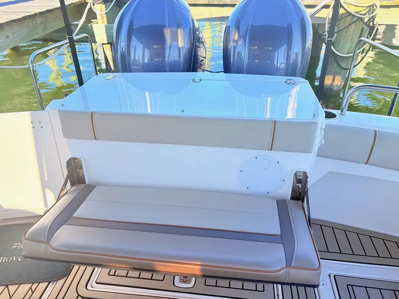Slide: The Image of Rear seating of 2023 Cutwater 32 Coupe with engines in background. - 11